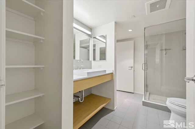 255 N Sierra St Unit 606, Reno, NV 89501 - full bathroom featuring toilet, a shower stall, tile patterned flooring, vanity, and recessed lighting