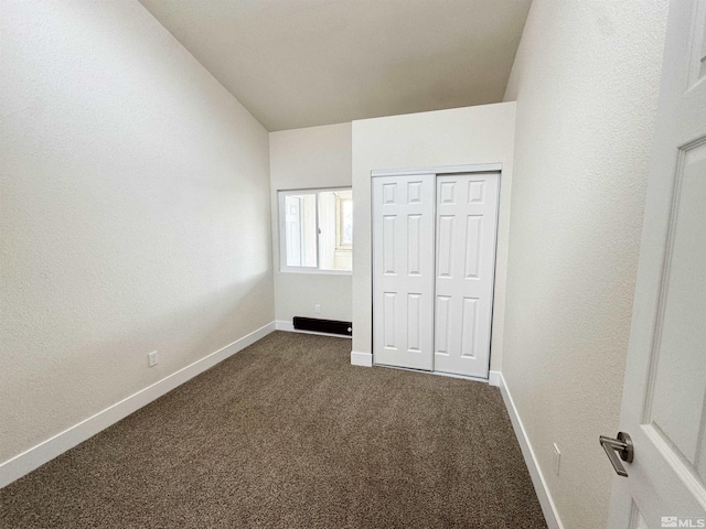 2500 Tripp Dr Unit 4, Reno, NV 89512 - unfurnished bedroom featuring baseboards, dark carpet, a closet, and vaulted ceiling