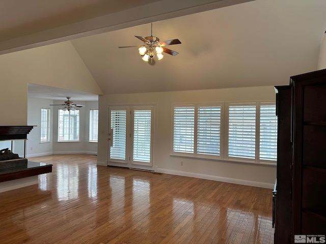 972 Springfield, Gardnerville, NV 89460 - unfurnished living room featuring ceiling fan, baseboards, high vaulted ceiling, light wood finished floors, and a multi sided fireplace