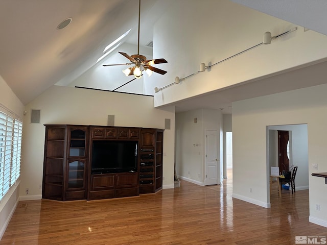 972 Springfield, Gardnerville, NV 89460 - unfurnished living room with a ceiling fan, light wood-style floors, high vaulted ceiling, and baseboards