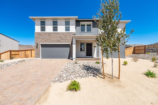 401 Pah Rah Ridge Dr Unit Harris 35, Sparks, NV 89441 - view of front of house with fence, stone siding, a garage, driveway, and stucco siding