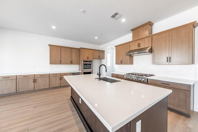 401 Pah Rah Ridge Dr Unit Harris 35, Sparks, NV 89441 - kitchen featuring a sink, under cabinet range hood, light wood finished floors, light countertops, and recessed lighting