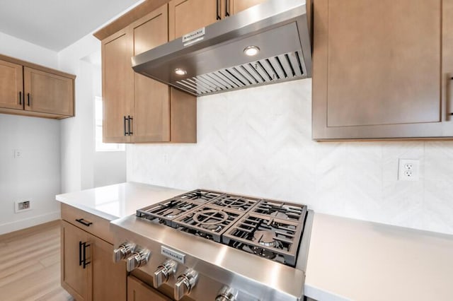 401 Pah Rah Ridge Dr Unit Harris 35, Sparks, NV 89441 - kitchen with extractor fan, stainless steel gas cooktop, backsplash, and light countertops
