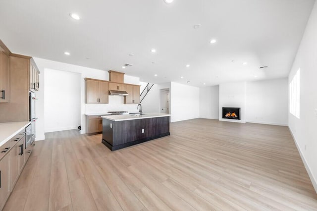 401 Pah Rah Ridge Dr Unit Harris 35, Sparks, NV 89441 - kitchen with a sink, a center island with sink, under cabinet range hood, light countertops, and recessed lighting