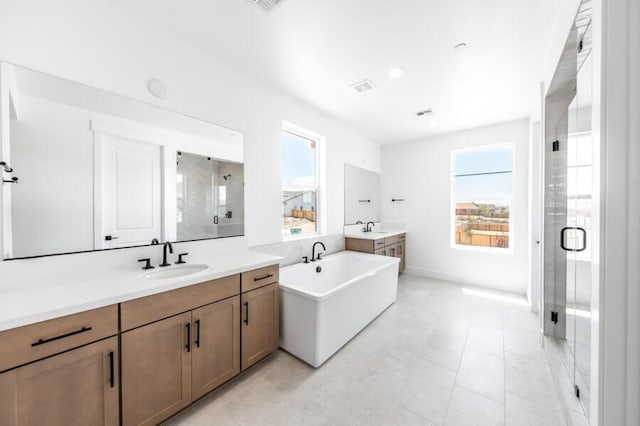 401 Pah Rah Ridge Dr Unit Harris 35, Sparks, NV 89441 - full bath with a stall shower, two vanities, a freestanding tub, and baseboards