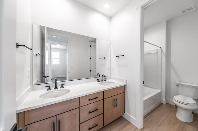 401 Pah Rah Ridge Dr Unit Harris 35, Sparks, NV 89441 - bathroom featuring toilet, double vanity, washtub / shower combination, and baseboards