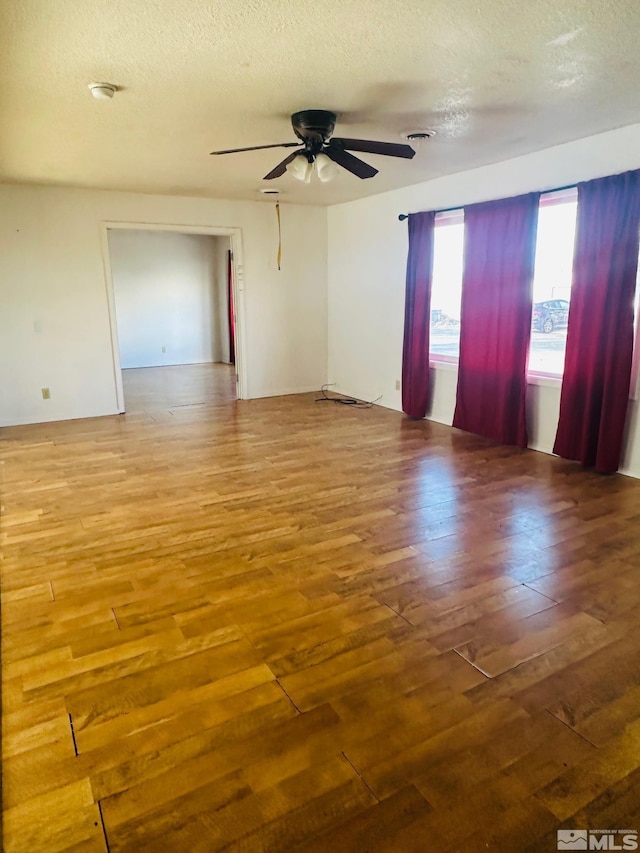 815 16th St, Lovelock, NV 89419 - unfurnished room featuring a ceiling fan, wood finished floors, and a textured ceiling