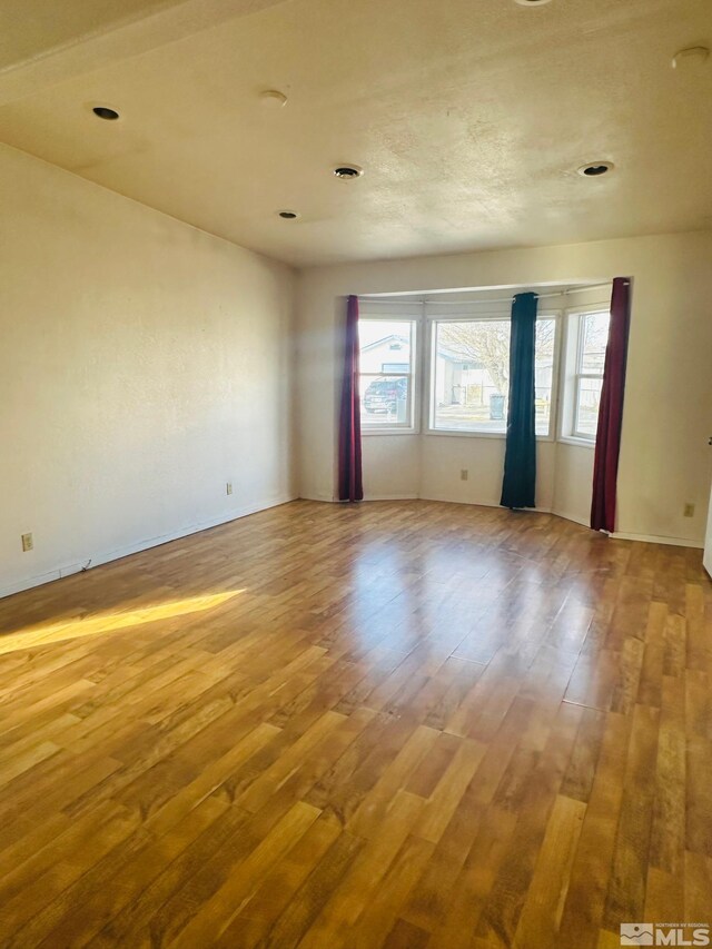 815 16th St, Lovelock, NV 89419 - spare room featuring hardwood / wood-style flooring and baseboards