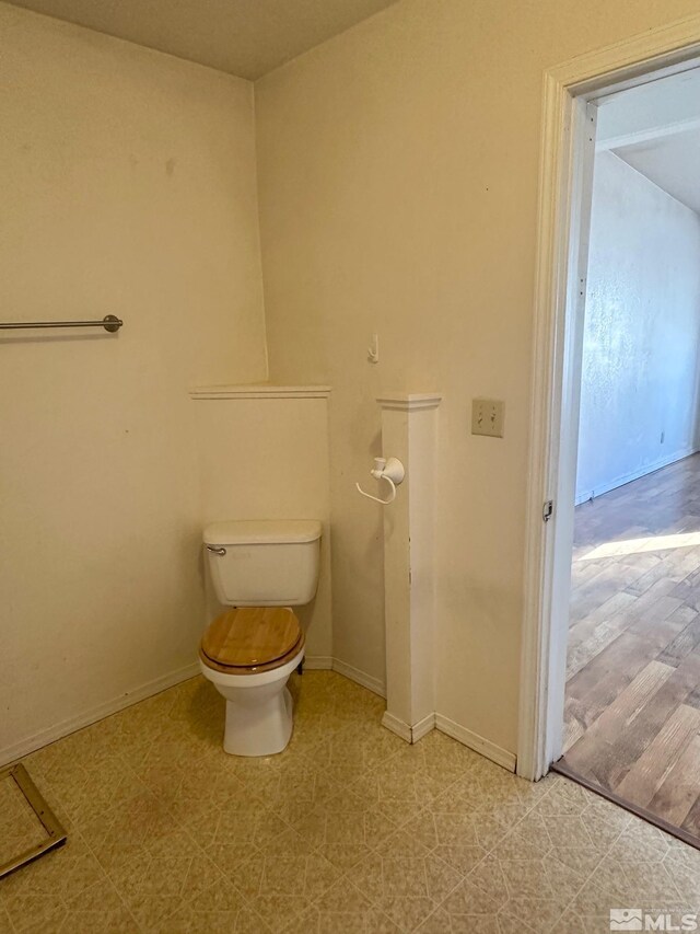 815 16th St, Lovelock, NV 89419 - bathroom featuring toilet, tile patterned floors, and baseboards