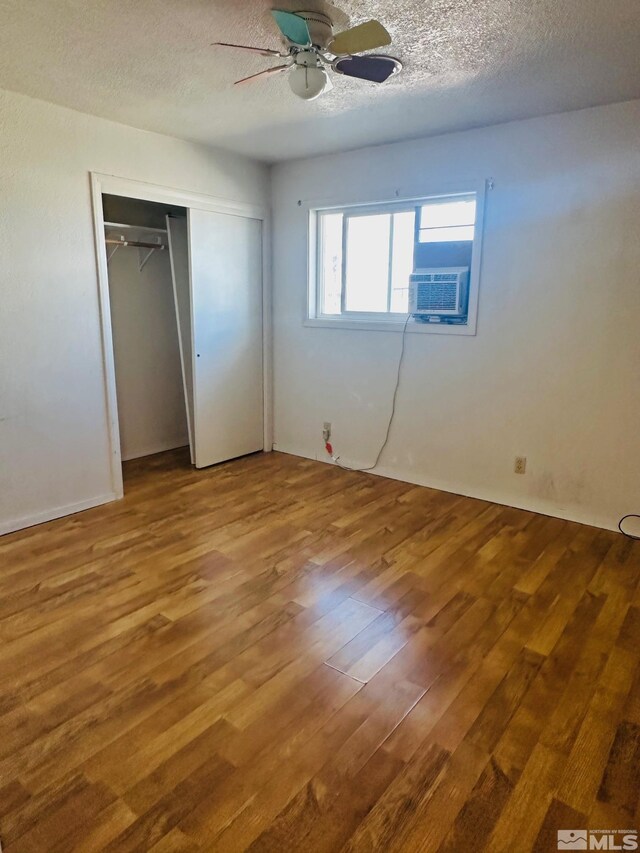 815 16th St, Lovelock, NV 89419 - unfurnished bedroom with wood finished floors, a textured ceiling, a ceiling fan, and a closet