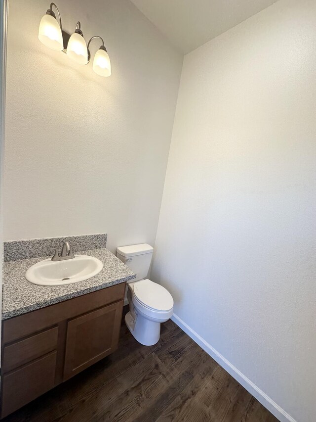 1304 Serenity Cir Lot 24, Fernley, NV 89408 - half bath featuring toilet, vanity, wood finished floors, and baseboards