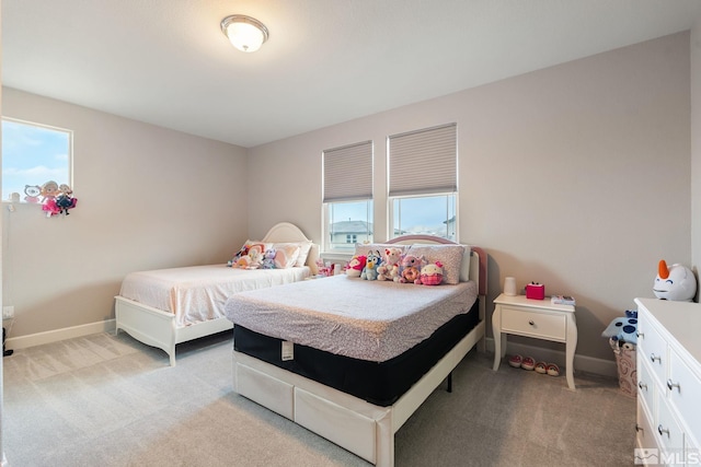 bedroom with light carpet and baseboards