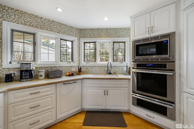 6350 Green Ranch Rd, Reno, NV 89519 - kitchen with a sink, appliances with stainless steel finishes, a warming drawer, decorative backsplash, and recessed lighting