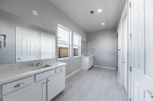 full bathroom featuring vanity, baseboards, and recessed lighting