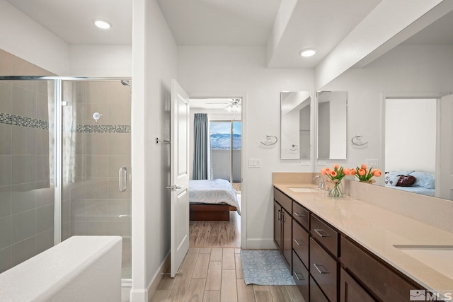 11223 Freedom Range Ln, Reno, NV 89521 - ensuite bathroom with wood finished floors, baseboards, a shower stall, double vanity, and recessed lighting