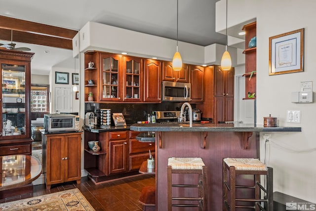 400 Fairview Blvd Unit 155, Incline Village, NV 89451 - kitchen featuring stainless steel appliances, open shelves, a kitchen breakfast bar, dark countertops, and dark wood-style flooring