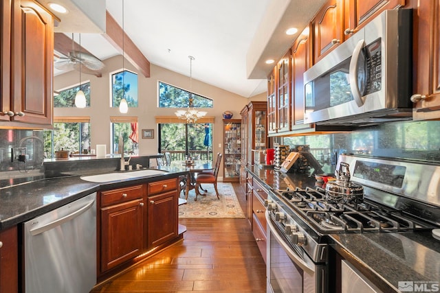 400 Fairview Blvd Unit 155, Incline Village, NV 89451 - kitchen featuring stainless steel appliances, a sink, dark wood-style floors, backsplash, and a chandelier