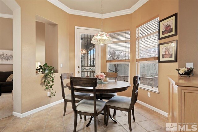 1556 Diamond Country Dr, Reno, NV 89521 - dining space featuring ornamental molding, light tile patterned floors, and a chandelier