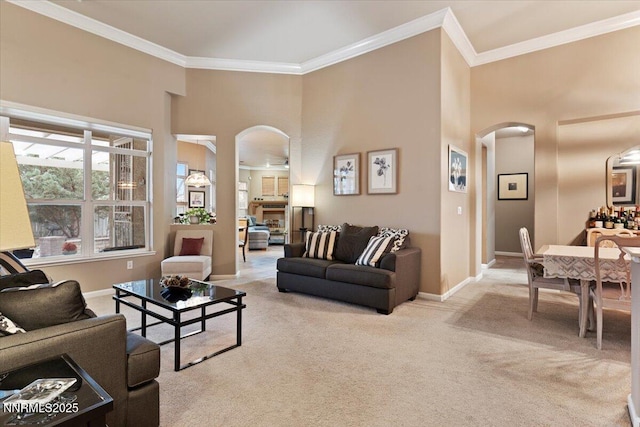 1556 Diamond Country Dr, Reno, NV 89521 - living area with arched walkways, light colored carpet, crown molding, and a high ceiling