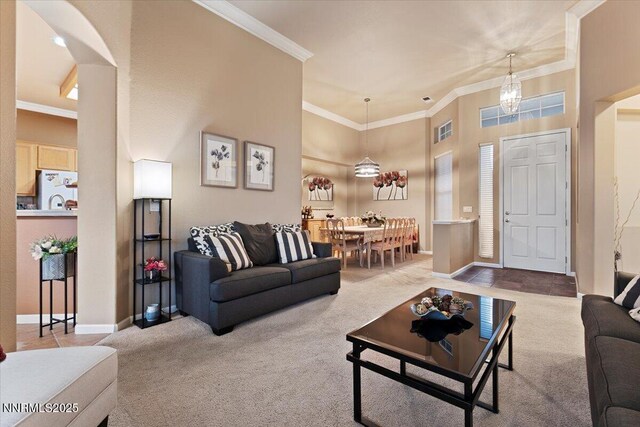 1556 Diamond Country Dr, Reno, NV 89521 - carpeted living room with ornamental molding, arched walkways, and a high ceiling