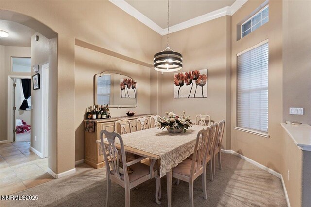 1556 Diamond Country Dr, Reno, NV 89521 - dining space featuring arched walkways, ornamental molding, light colored carpet, a chandelier, and a towering ceiling