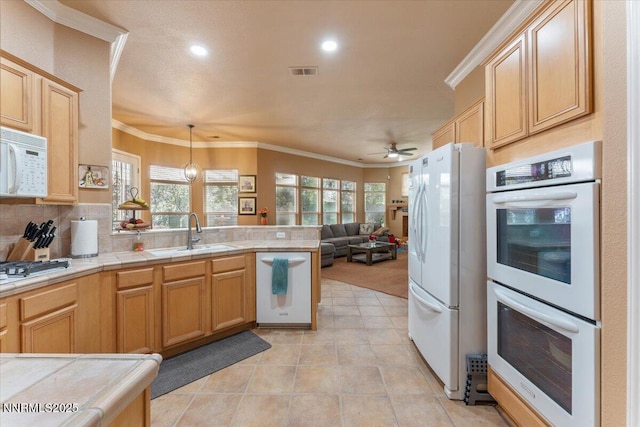 1556 Diamond Country Dr, Reno, NV 89521 - kitchen featuring white appliances, a peninsula, ornamental molding, ceiling fan, and recessed lighting