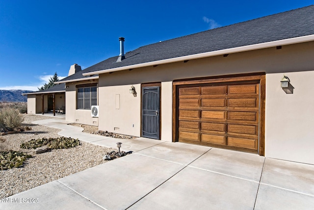 10 Dee Ct, Smith Valley, NV 89444 - doorway to property featuring stucco siding, driveway, roof with shingles, a chimney, and an attached garage