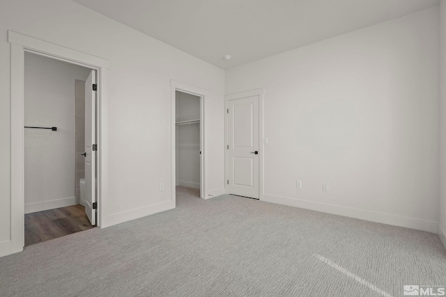 1212 Grove St Unit 73, Carson City, NV 89701 - unfurnished bedroom featuring carpet, baseboards, a spacious closet, connected bathroom, and a closet