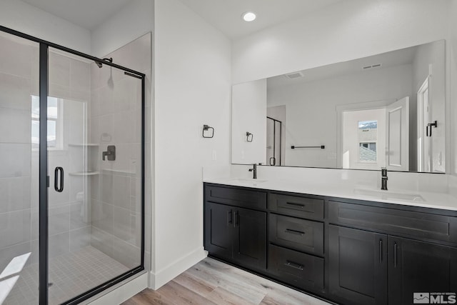 1212 Grove St Unit 73, Carson City, NV 89701 - full bath featuring wood finished floors, a stall shower, double vanity, healthy amount of natural light, and recessed lighting