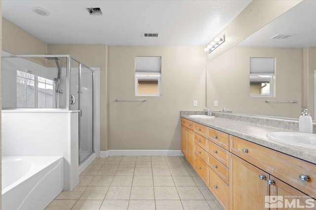 1950 Red Willow Dr, Reno, NV 89521 - bathroom featuring tile patterned flooring, double vanity, a shower stall, a garden tub, and baseboards