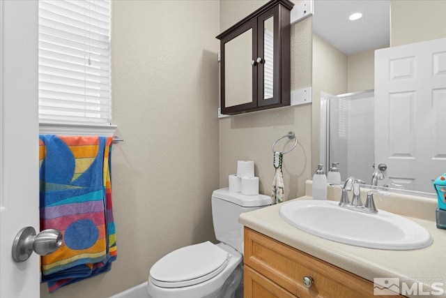 1950 Red Willow Dr, Reno, NV 89521 - bathroom featuring an enclosed shower, toilet, vanity, and a textured wall