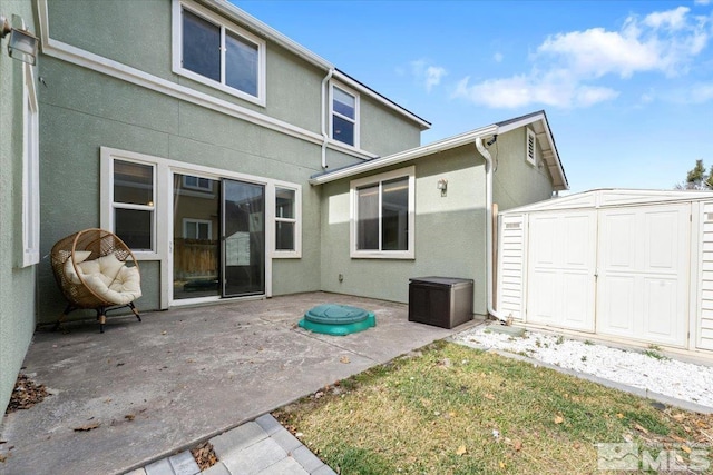 1950 Red Willow Dr, Reno, NV 89521 - back of house featuring a storage shed, a patio, stucco siding, and an outdoor structure