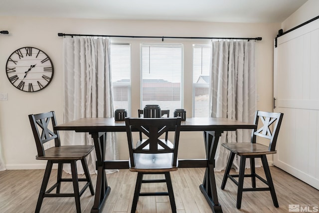 276 Greywall Ct, Dayton, NV 89403 - dining room with a barn door, light wood-style flooring, and baseboards