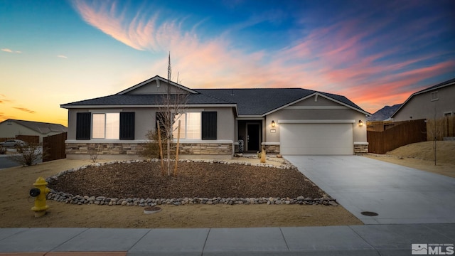 276 Greywall Ct, Dayton, NV 89403 - single story home featuring stone siding, stucco siding, an attached garage, and driveway