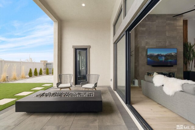 balcony featuring an outdoor fire pit and a patio