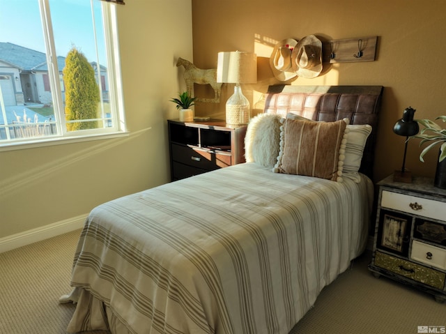 carpeted bedroom with baseboards