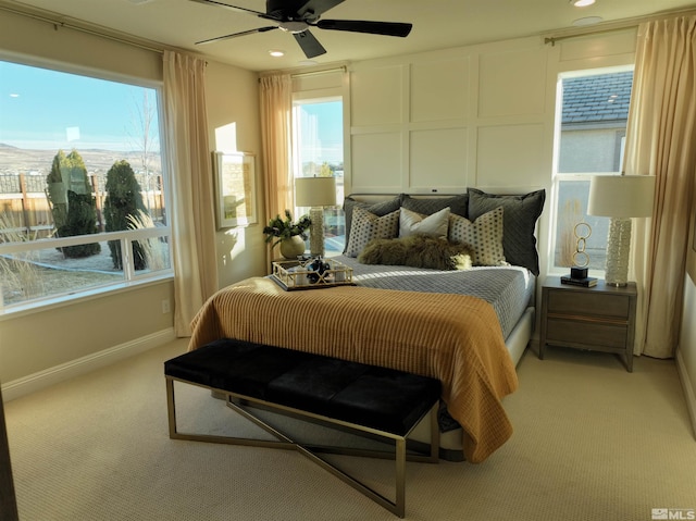 bedroom with light colored carpet, multiple windows, baseboards, ceiling fan, and recessed lighting