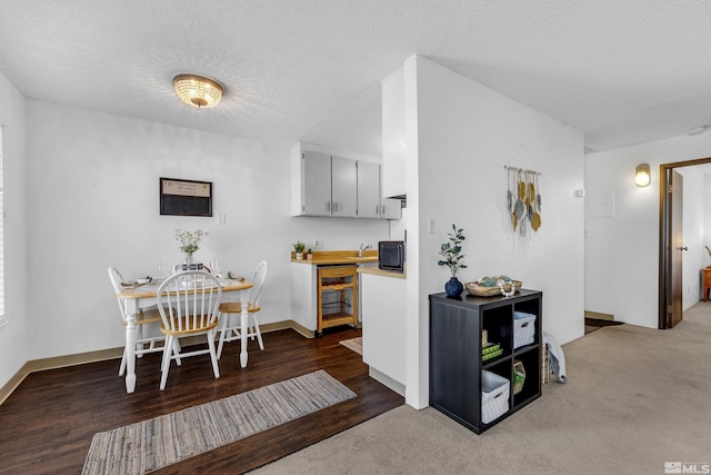 400 S Saliman Rd Unit G56, Carson City, NV 89701 - kitchen featuring a textured ceiling, light countertops, baseboards, black microwave, and carpet