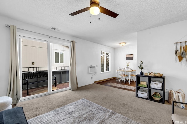 400 S Saliman Rd Unit G56, Carson City, NV 89701 - carpeted living area with a textured ceiling, a wall unit AC, and ceiling fan