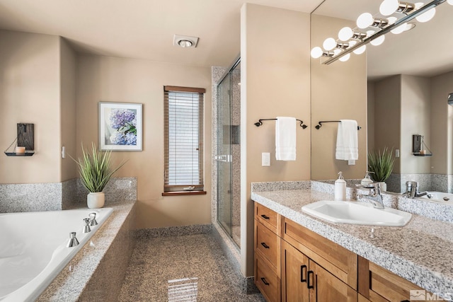 full bath with a shower stall, vanity, and a bath