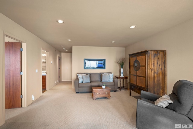 living area featuring light carpet and recessed lighting