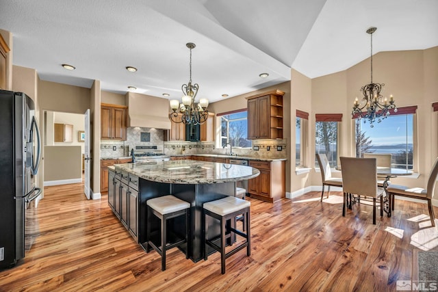 227 S Earlham, Reno, NV 89511 - kitchen with a chandelier, custom exhaust hood, freestanding refrigerator, open shelves, and recessed lighting