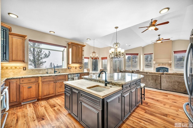 227 S Earlham, Reno, NV 89511 - kitchen featuring a sink, a chandelier, light wood finished floors, a ceiling fan, and vaulted ceiling