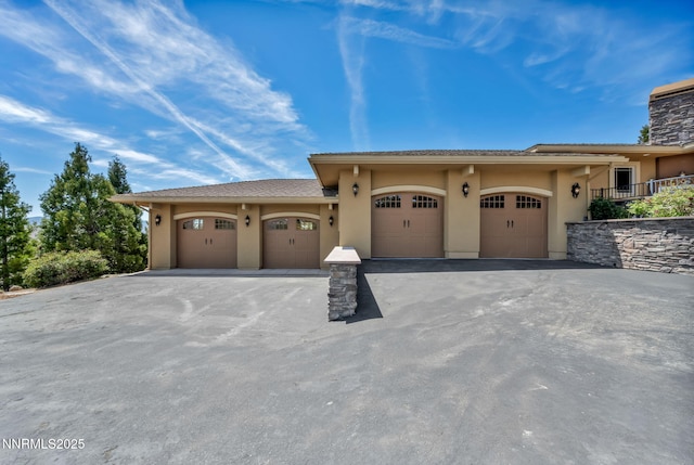 227 S Earlham, Reno, NV 89511 - view of front of house with stucco siding, asphalt driveway, and a garage