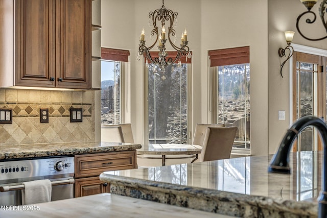 227 S Earlham, Reno, NV 89511 - kitchen with a chandelier, decorative backsplash, and light stone countertops