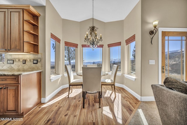 227 S Earlham, Reno, NV 89511 - dining space featuring a chandelier, baseboards, light wood finished floors, and a high ceiling