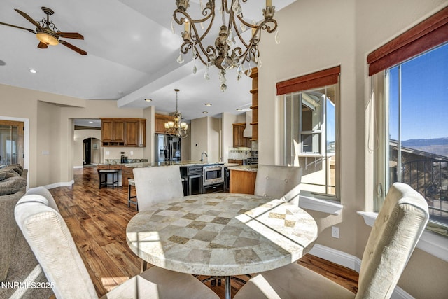 227 S Earlham, Reno, NV 89511 - dining room featuring a chandelier, wood finished floors, baseboards, a ceiling fan, and plenty of natural light