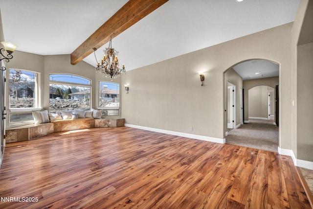 227 S Earlham, Reno, NV 89511 - unfurnished living room with hardwood / wood-style floors, arched walkways, baseboards, and a chandelier