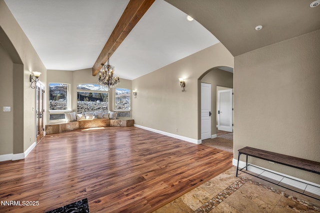 227 S Earlham, Reno, NV 89511 - unfurnished living room featuring a chandelier, wood finished floors, arched walkways, baseboards, and recessed lighting