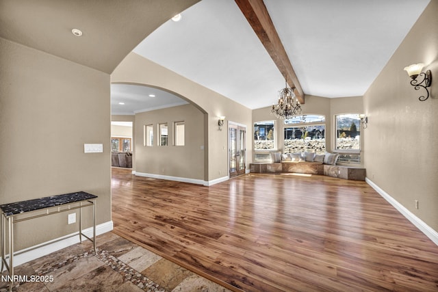 227 S Earlham, Reno, NV 89511 - unfurnished living room with a chandelier, wood finished floors, baseboards, arched walkways, and recessed lighting